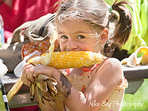 Girl Eating Corn at the Fair