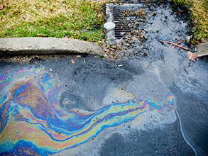 oil and debris flowing into a storm drain